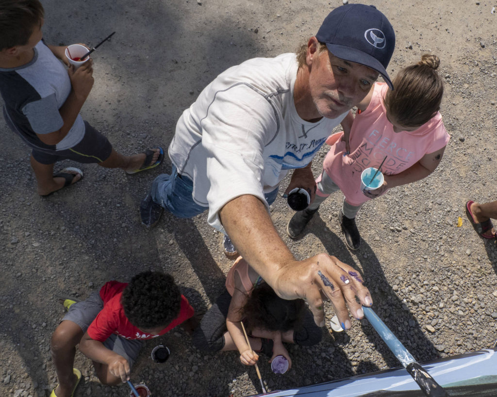 Wyland, a Laguna Beach-based artist, paints a mural with Southeast Alaska children