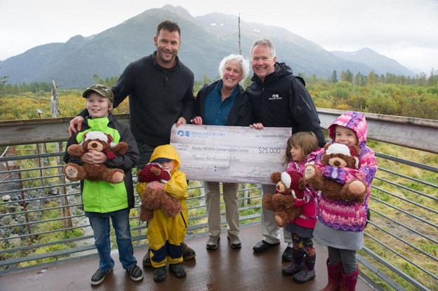 Princess Cruises Vice President of Public Affairs Ralph Samuels presents a $25,000 check to the Alaska Wildlife Conservation Center Board Member Karen Cowart